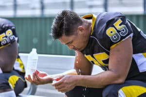 overheating football player in need of an outdoor evaporative cooler