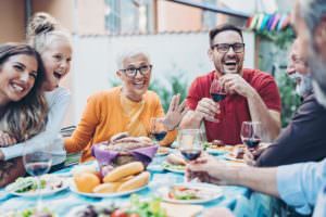 family having Mother's Day dinner on a backyard patio