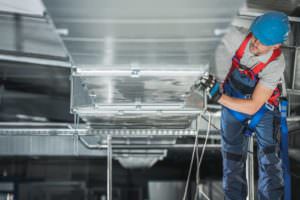 industrial worker using an industrial fan